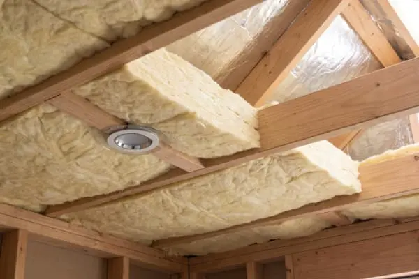 Non combustible insulation batts installed in an Australian roof space with safe clearance around a recessed downlight